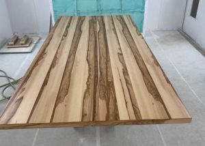 wooden table top in a spray booth